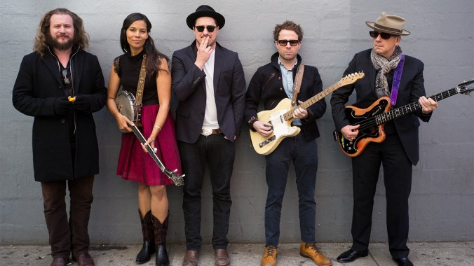 This Nov. 9, 2014 photo shows, from left, Jim James, Rhiannon Giddens, Marcus Mumford, Taylor Goldsmith and Elvis Costello posing in in New York in promotion of "Lost on the River: The New Basement Tapes," an album produced by T Bone Burnett and created by the musicians using lyrics written by Bob Dylan for the legendary "basement tapes" recordings. (Photo by Drew Gurian/Invision/AP)
