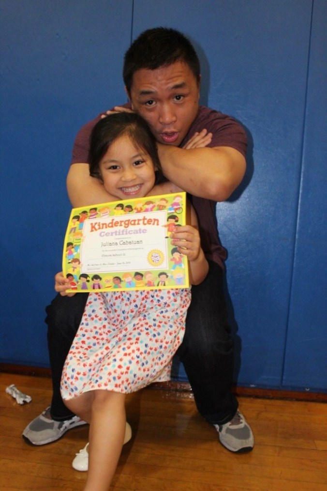 Our niece goes to AllStar too, and is currently a grey-white belt holder. For her kindergarten graduation photo with her uncle, they decided to show how to do a proper choke. 
